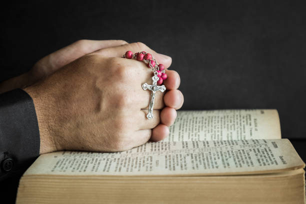 istock Opened bible in the quiet, dark atmosphere. Prayer time on sunday. 834222506