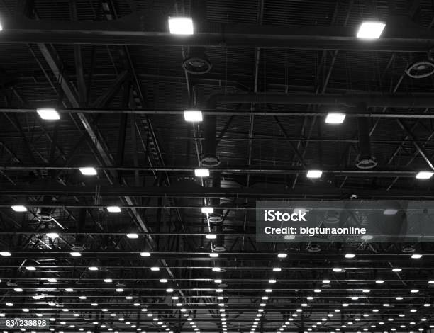 Lights And Ventilation System In Long Line On Ceiling Of The Dark Office Industrial Building Exhibition Hall Ceiling Construction Stock Photo - Download Image Now