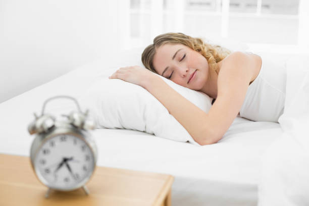 istock Pretty peaceful blonde lying in bed sleeping 834251080