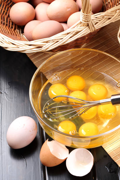 istock Eggs: Whisk, Bowl and Eggs isolated on a Black table 834256782