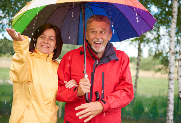 istock Man and woman under umbrella 834262242