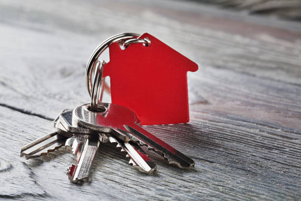 istock estate concept with key, red keychain with house symbol 834262996