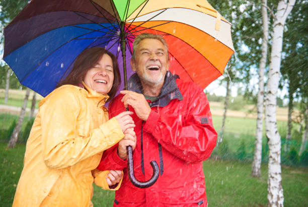 istock Couple looking for shelter with umbrella 834263222