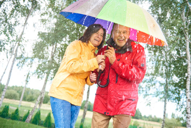 istock Couple with a rainbow umbrella 834263524