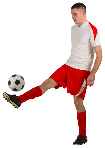 istock Fit football player playing with ball 834264070