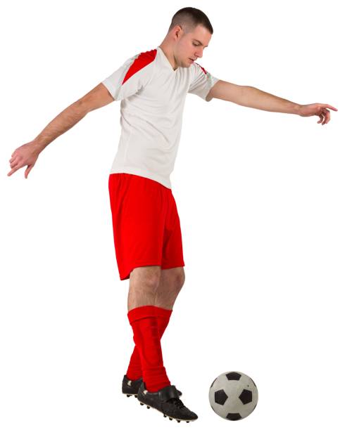 istock Fit football player playing with ball 834264102