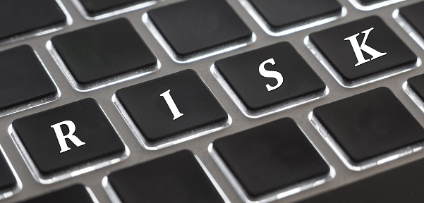 The white letter of Risk on computer keyboard background for design in your Presentation