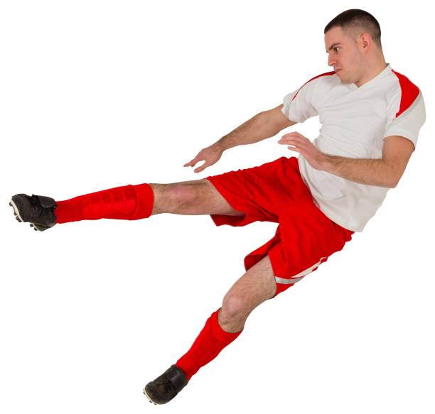 istock Fit football player playing and kicking 834264688