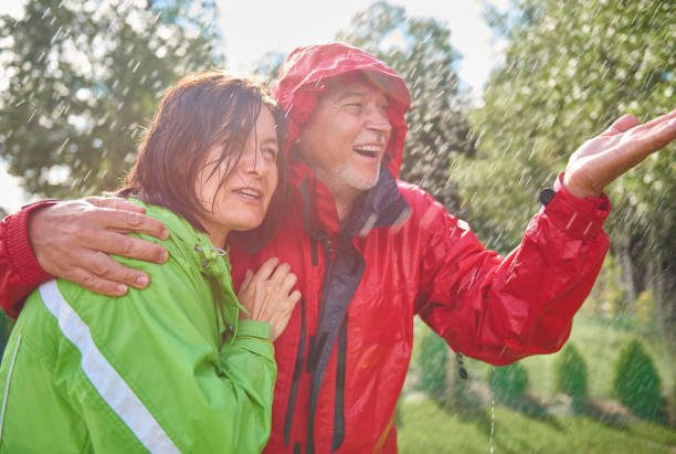 istock Senior couple embracing in rain 834265624