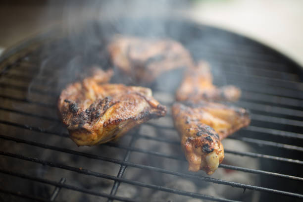 Grilled chicken wing and bud in wooden stick. Thai traditional style street food or appetizer cooking