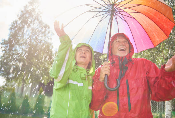 istock Senior couple playing with rain 834276616