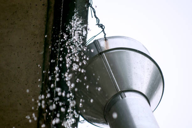 istock The old drain pipe with water agai the wall 834297356