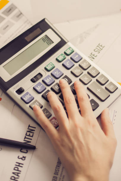 istock Closeup of Marketing Expert Hand Using Calculator 834298226