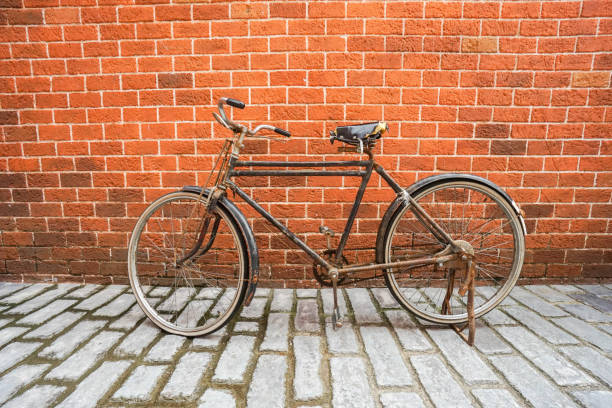 istock vintage and old bicycle on concrete road with brick background 834298826