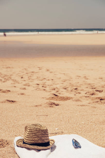 istock Towel, sunglasses, hat on sand, Beach holiday, Cornwall. 834337296