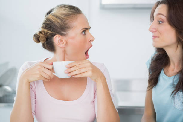 istock Stunned blonde looking at her quiet friend 834338166