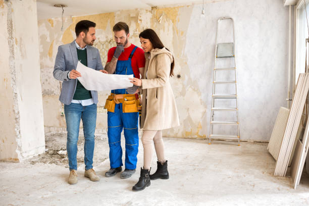 istock Young couple shows to builder handyman problem about renovations their home 834341044