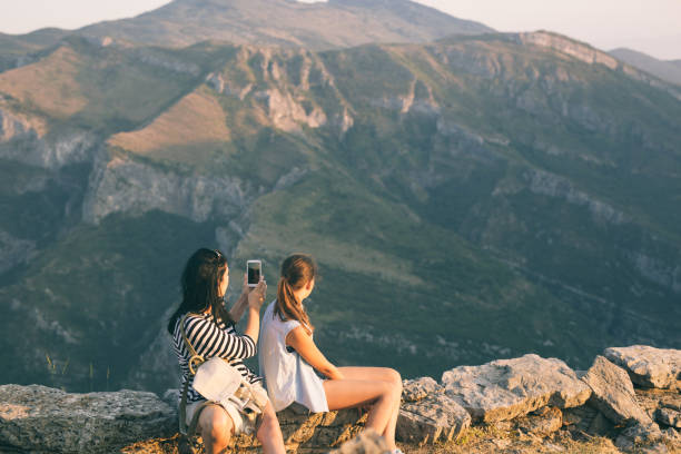 istock Mother and daugther looking on mountain peak 834343908