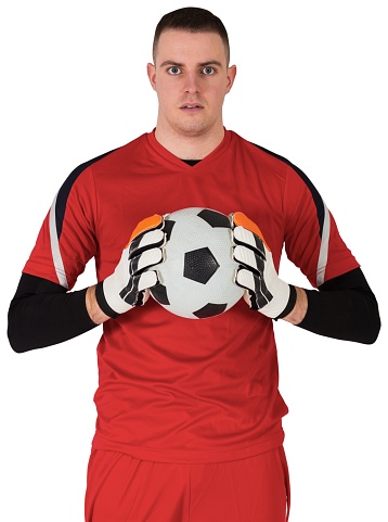 Goalkeeper in red looking at camera on white background