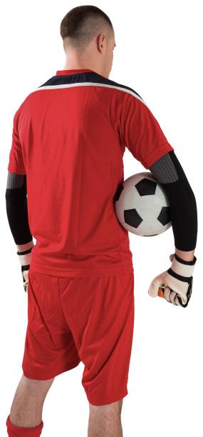 istock Goalkeeper in red holding the ball 834346366