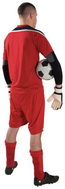 istock Goalkeeper in red holding the ball 834346468
