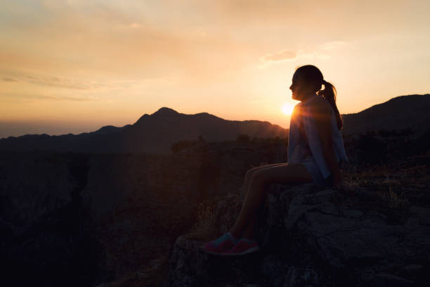 istock Girl looking at sunset on mountain 834356514