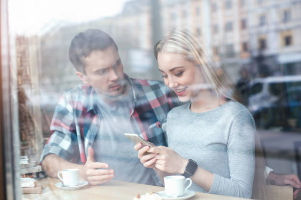 istock Nice looking man and woman in cafe 834366446