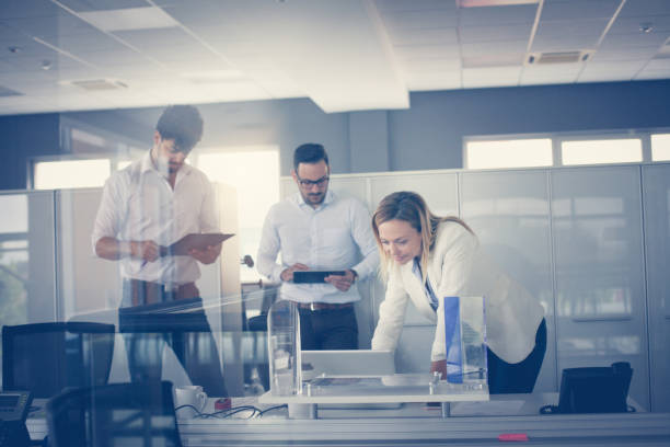 istock Business people working in office together. Three colleague in office. 834376164