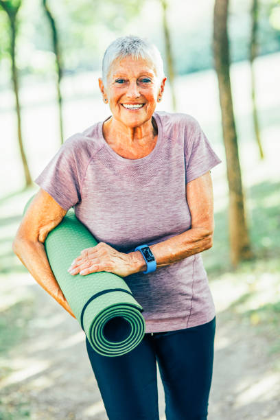 istock Senior sportswoman holding an exercise mat 834405038