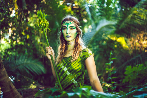 Jungle Goddess Beautiful woman with creative green makeup, blending in with the jungle. cosplay photos stock pictures, royalty-free photos & images