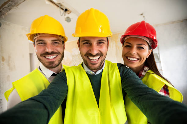 funny architects workers taking selfie at contruction site - female construction telephone building contractor imagens e fotografias de stock