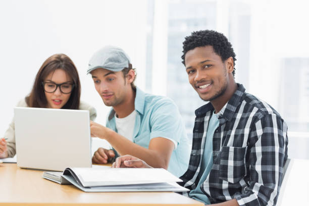 istock Artists working at desk in creative office 834422824