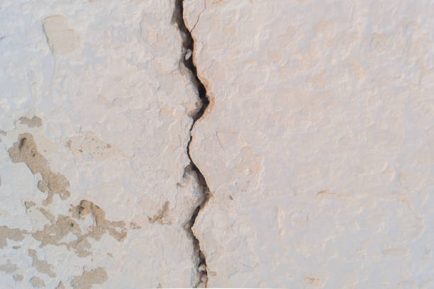 Cracks in the concrete screed. Abstract background.