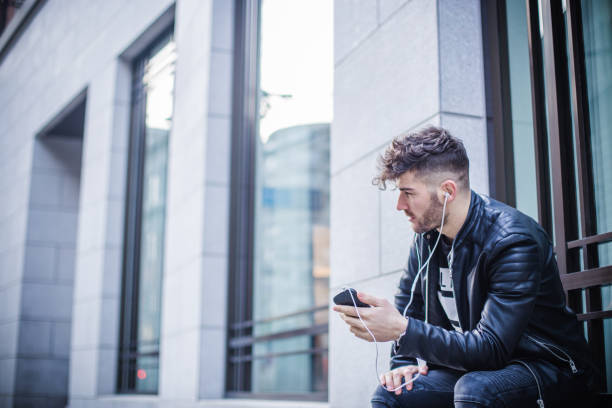 istock Handsome young man listening music 834428190