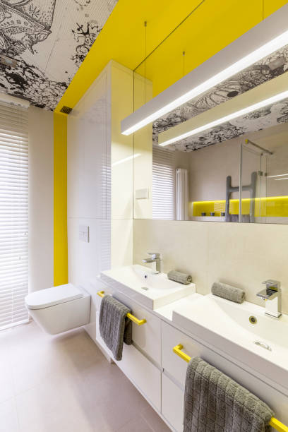 Neon yellow bathroom design idea White and neon yellow bathroom design idea, yellow handles, double sink, toilet, graphic ceiling and window guest bathroom stock pictures, royalty-free photos & images
