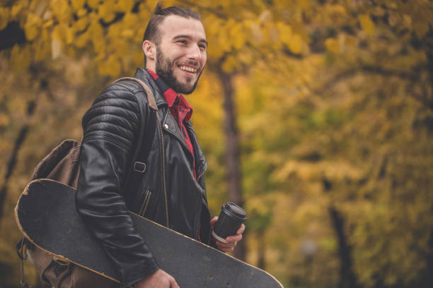 istock Smiling skater man having coffee break 834437382