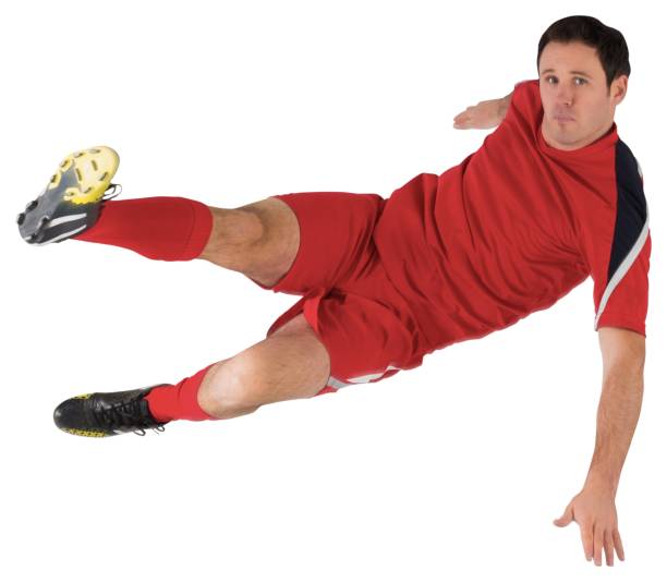 istock Football player in red kicking 834437996