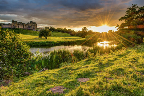 The River Aln runs through Northumberland from Alnham to Alnmouth. Seen here below Alnwick Town and Castle on the skyline, as the sun goes down