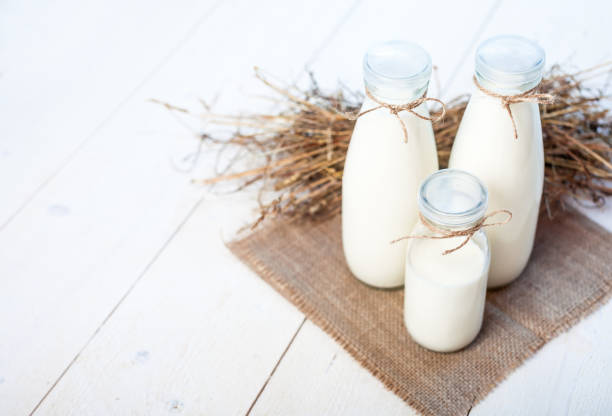 istock bottles of milk on a wooden rustic table. copy space 834459324