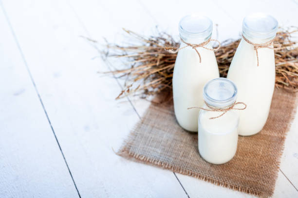 istock bottles of milk on a wooden rustic table. 834460014