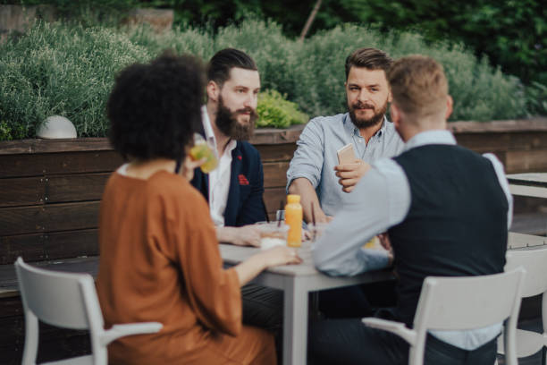 istock Group of business people sitting by the table and talking 834460810