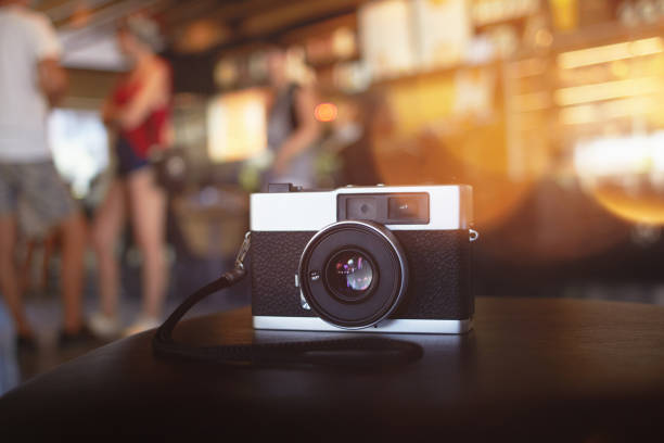Vintage film rangefinder camera at the cafe table