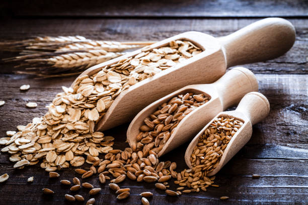 istock Oat, spelt and flax seeds on rustic wooden table 834468592