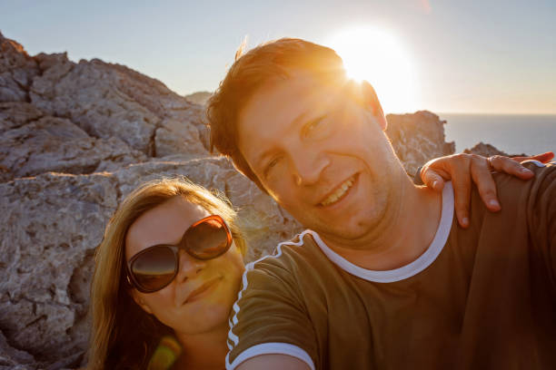 istock Happy traveling couple making selfie mountains background 834480976