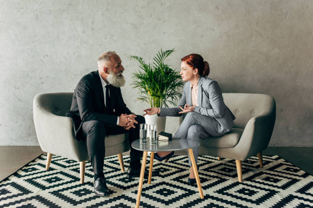 istock stylish mature business partners conversing in loft office 834518076