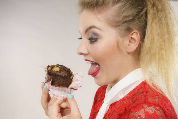 istock Attractive woman holds cake in hand 834518516
