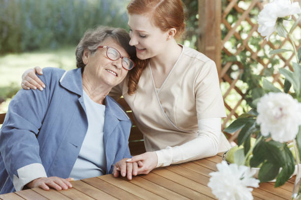 istock Senior woman hugs young assistant 834528876