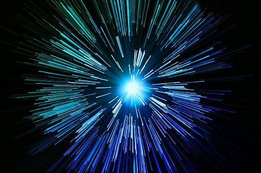 shot of star like celestial motion zoom implying space travel at high speed through a galaxy or solar system, ideal for use an a semi abstract image mimicking universal properties of gravity, movement and colour. The zoom effect has been obtained naturally and not with photoshop motion blur.