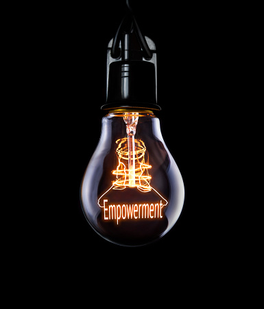 Hanging lightbulb with glowing Empowerment concept.