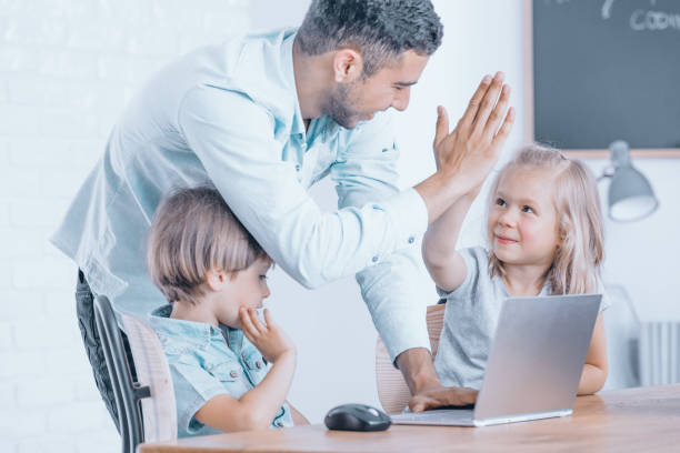 istock Happy teacher congratulates girl 834557756